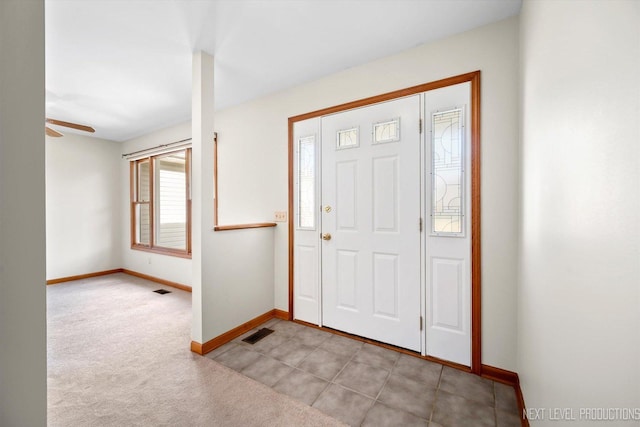 carpeted foyer with ceiling fan