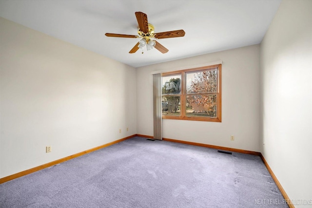 spare room featuring ceiling fan and carpet floors