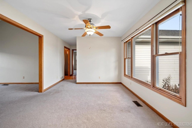 carpeted empty room with ceiling fan