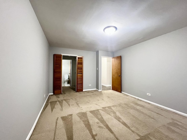 unfurnished bedroom featuring light carpet