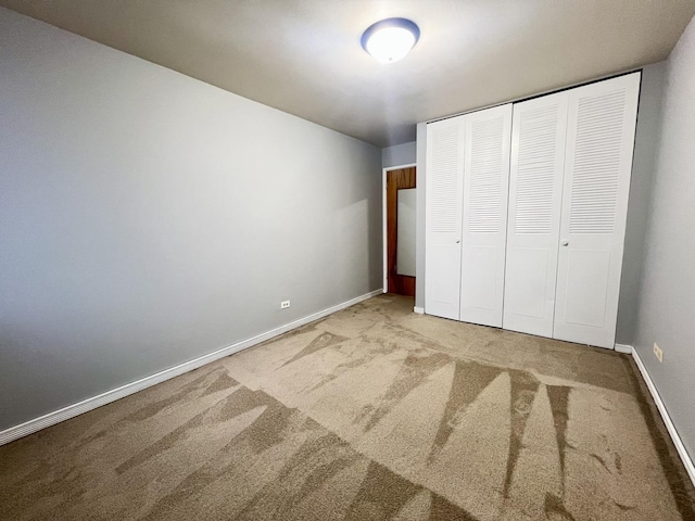 unfurnished bedroom with a closet and carpet floors