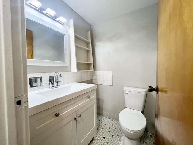 bathroom featuring toilet, decorative backsplash, vanity, and tile patterned floors