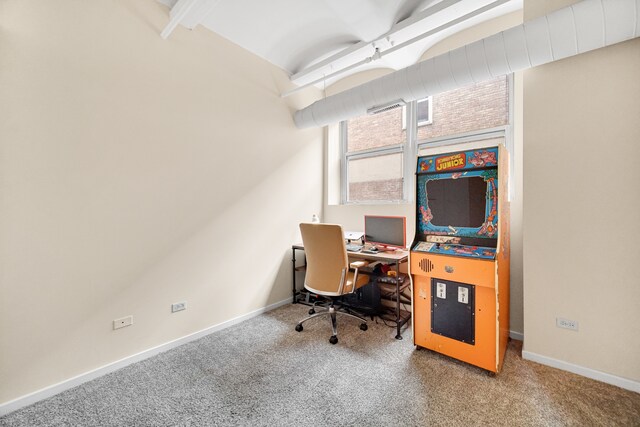 carpeted office featuring beamed ceiling