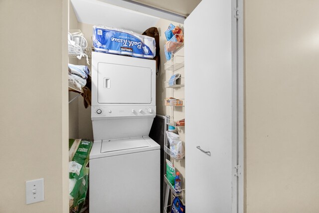 laundry area with stacked washing maching and dryer