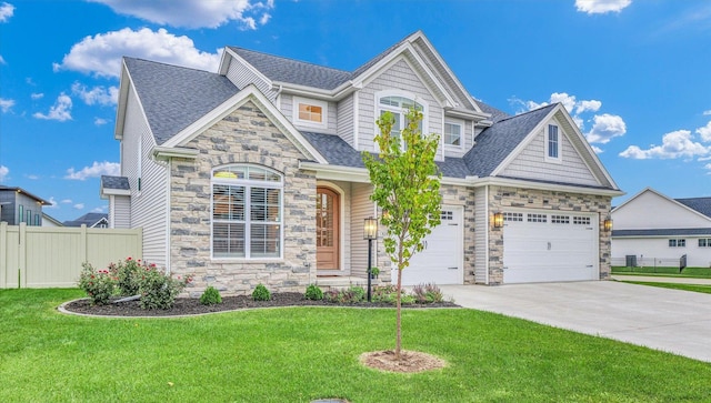 view of front facade featuring fence, driveway, stone siding, roof with shingles, and a front lawn