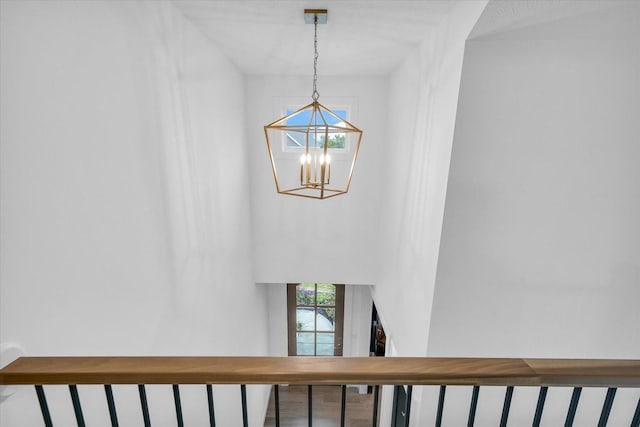 stairs with a chandelier