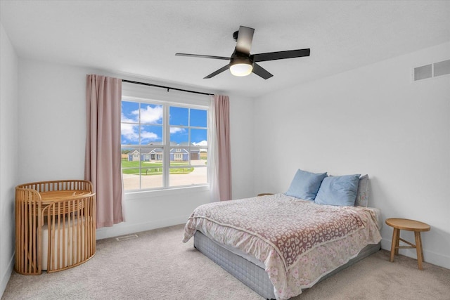 bedroom featuring carpet floors, baseboards, visible vents, and a ceiling fan