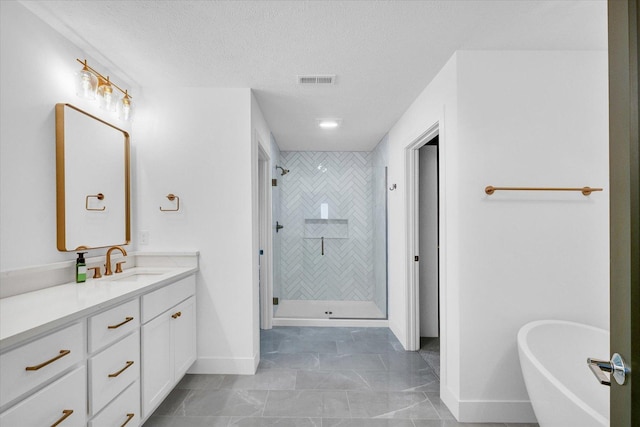 bathroom with a stall shower, visible vents, a freestanding bath, and vanity