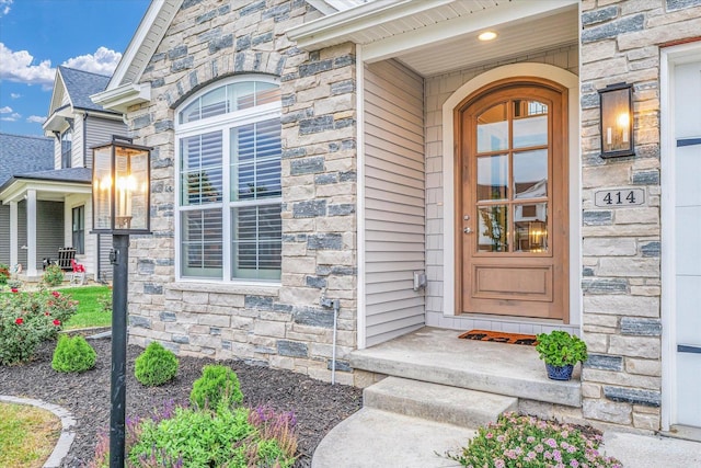 doorway to property featuring stone siding