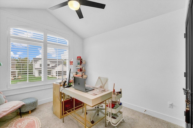 carpeted office space featuring baseboards, vaulted ceiling, and a ceiling fan