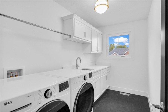 laundry room with washing machine and dryer, a sink, visible vents, baseboards, and cabinet space