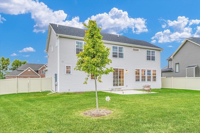 back of house featuring a patio, a lawn, a fenced backyard, and a gate