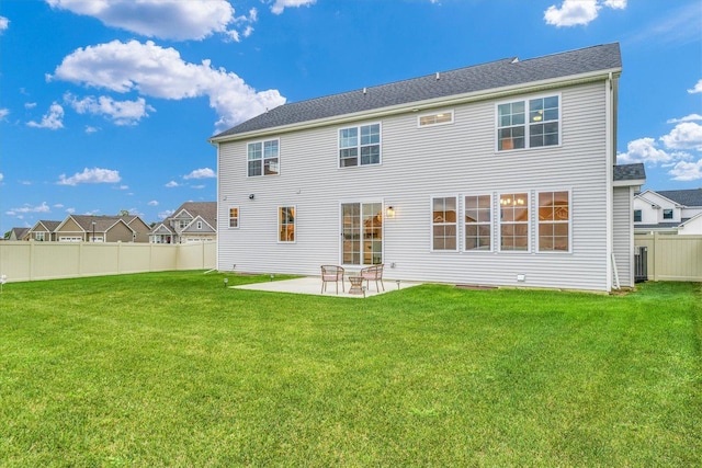 back of house with a patio area, a fenced backyard, and a yard