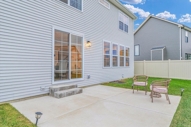 view of patio featuring entry steps and fence