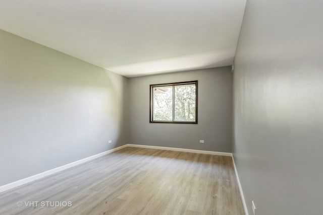 spare room featuring light hardwood / wood-style flooring