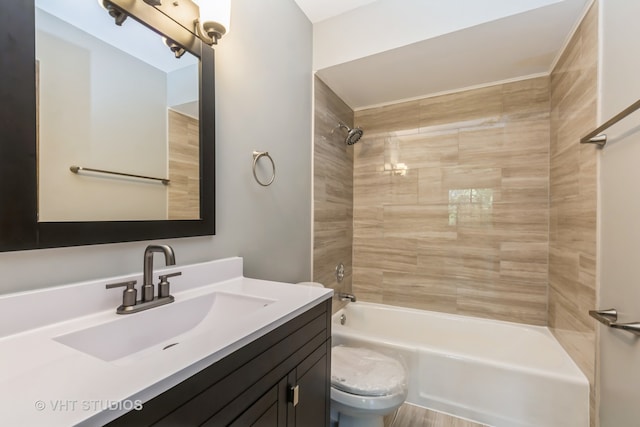 full bathroom with tiled shower / bath, vanity, and toilet