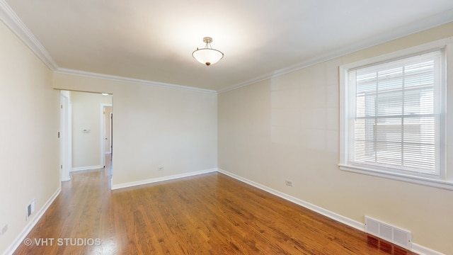 spare room with ornamental molding and hardwood / wood-style flooring