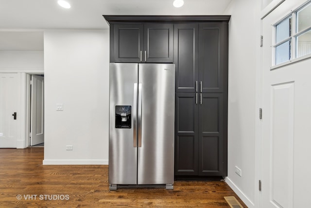 kitchen featuring dark hardwood / wood-style flooring and stainless steel fridge with ice dispenser