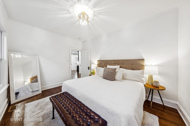 bedroom with crown molding and dark wood-type flooring