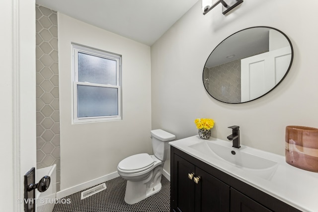 bathroom with tile patterned flooring, vanity, and toilet