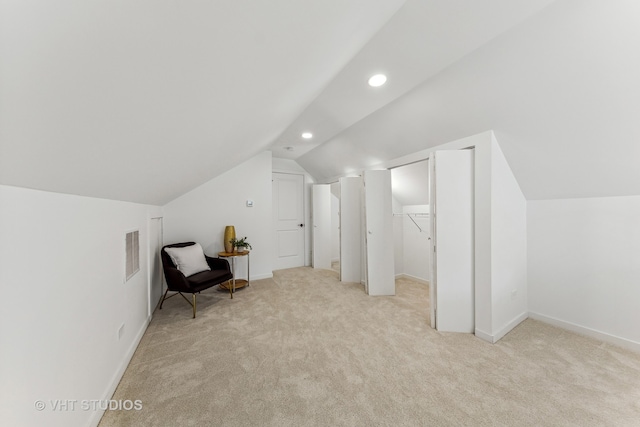 bonus room featuring light carpet and vaulted ceiling