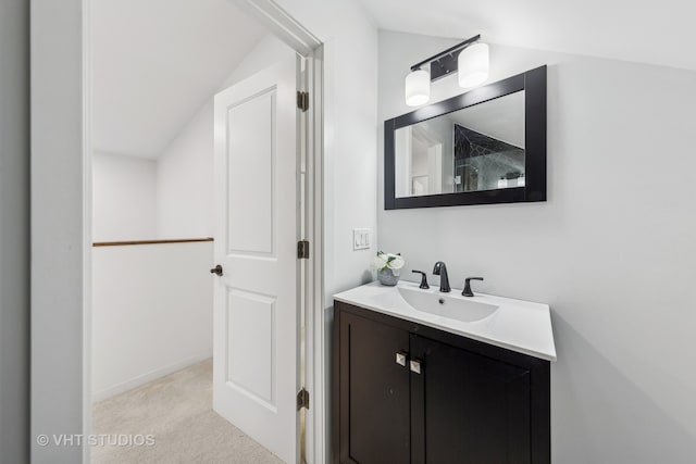 bathroom featuring vanity and vaulted ceiling