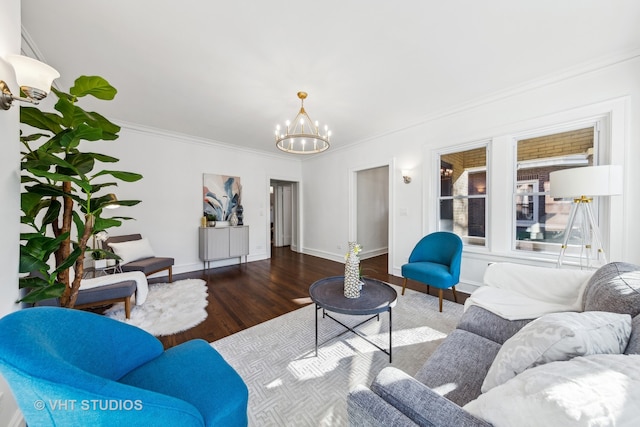 living room with crown molding, hardwood / wood-style floors, and a chandelier