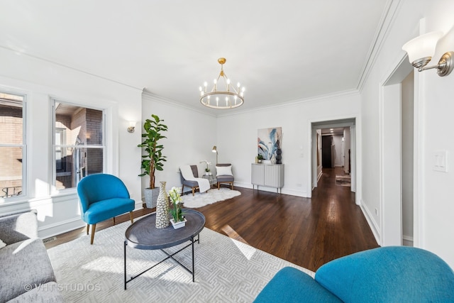 living room with hardwood / wood-style floors, a notable chandelier, and crown molding