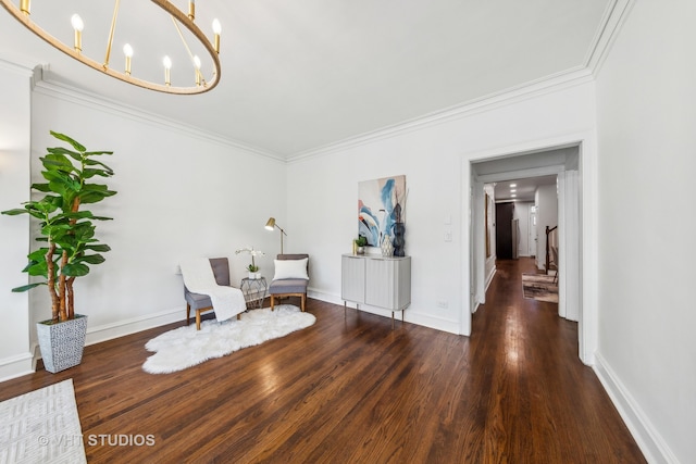 living area featuring dark hardwood / wood-style flooring, a notable chandelier, and ornamental molding