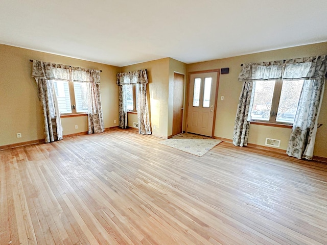 entryway featuring light wood-type flooring and a wealth of natural light