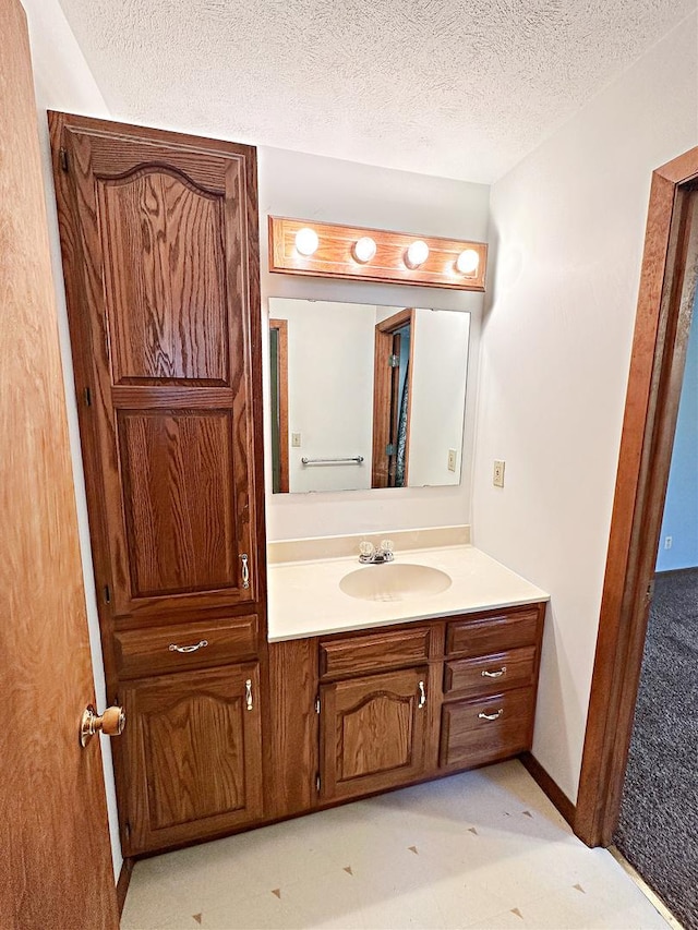 bathroom with vanity and a textured ceiling