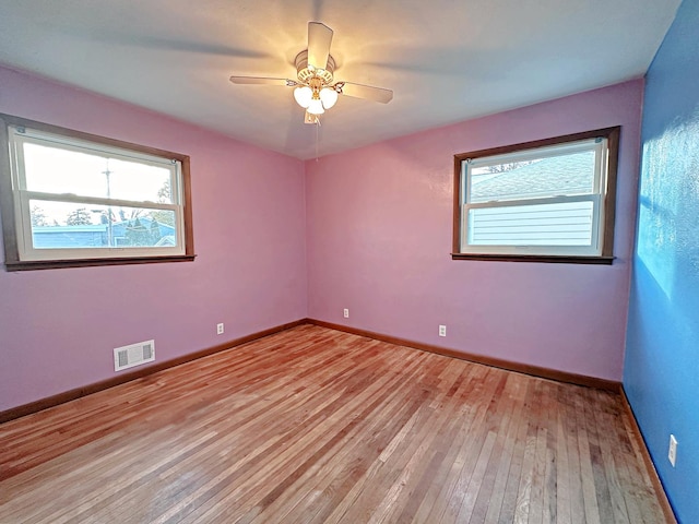 empty room featuring ceiling fan and light hardwood / wood-style floors