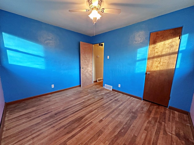 unfurnished bedroom featuring ceiling fan and hardwood / wood-style flooring