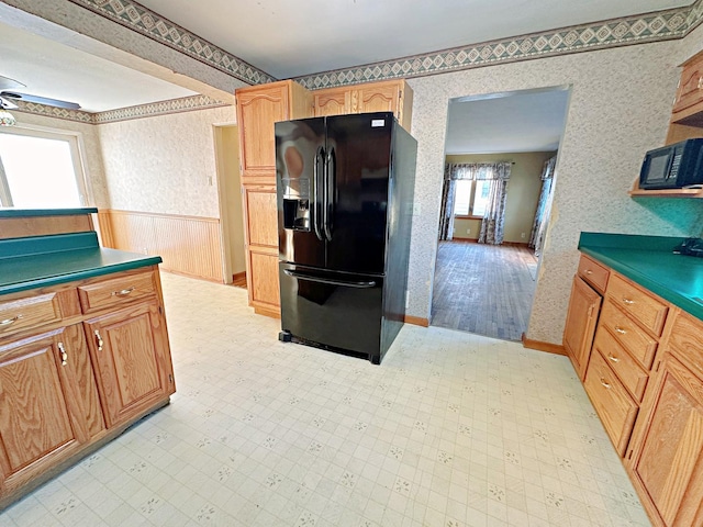 kitchen featuring ceiling fan, black appliances, and light wood-type flooring