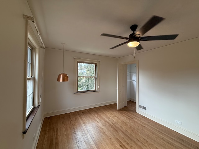 unfurnished room with light hardwood / wood-style flooring and ceiling fan