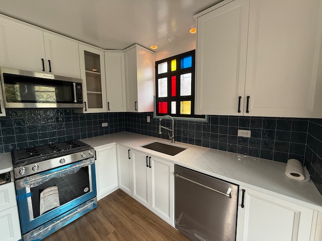 kitchen featuring dark hardwood / wood-style flooring, a wealth of natural light, sink, and appliances with stainless steel finishes