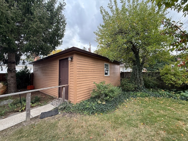 view of outbuilding with a lawn