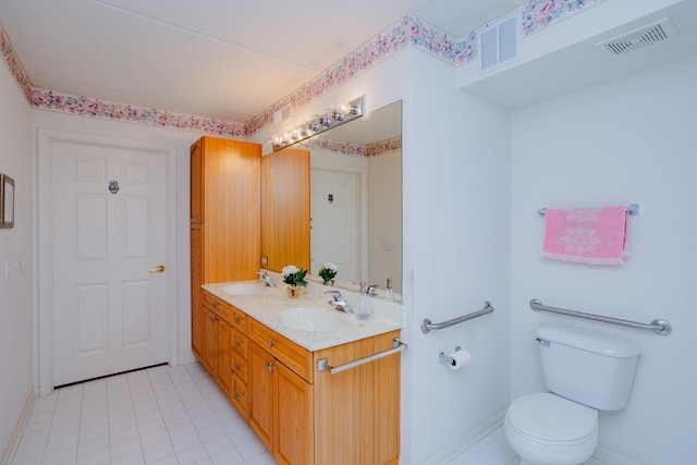 bathroom with tile patterned flooring, vanity, and toilet