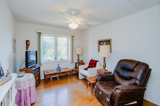 living area with ceiling fan and light wood-type flooring