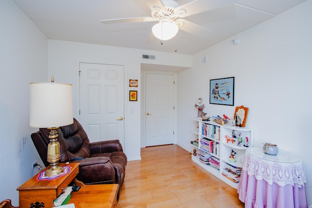 living area with ceiling fan and light wood-type flooring