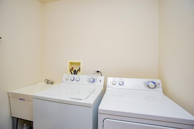 laundry area featuring washing machine and clothes dryer and sink