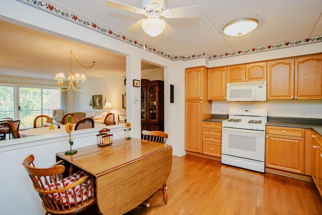 kitchen featuring light hardwood / wood-style flooring, ceiling fan with notable chandelier, pendant lighting, and white appliances