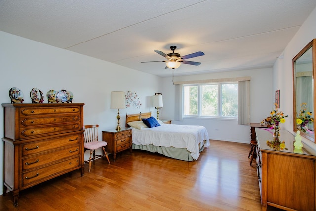 bedroom with ceiling fan and hardwood / wood-style floors