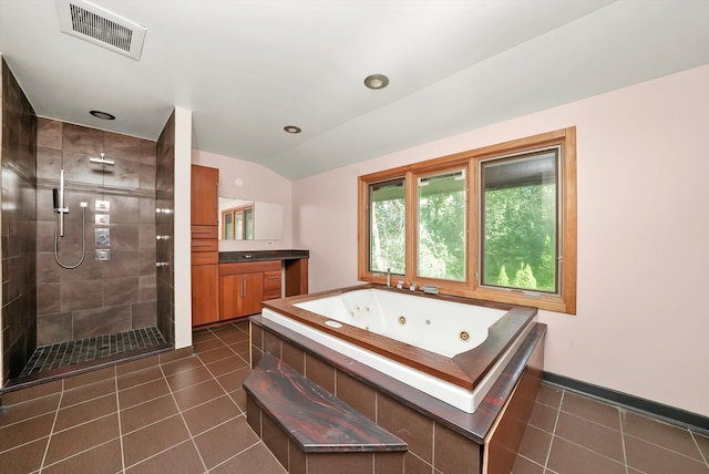 bathroom featuring tile patterned floors, vanity, lofted ceiling, and shower with separate bathtub