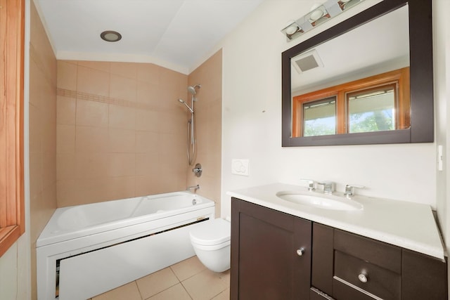 full bathroom featuring vanity, lofted ceiling, tile patterned floors, tiled shower / bath, and toilet