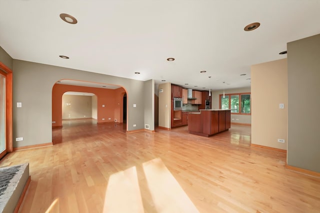 unfurnished living room featuring light wood-type flooring