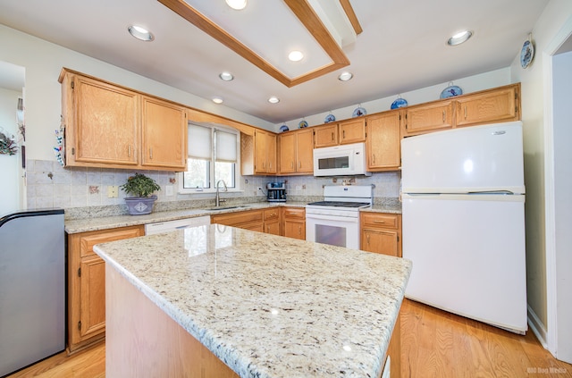 kitchen featuring white appliances, tasteful backsplash, light hardwood / wood-style flooring, and sink