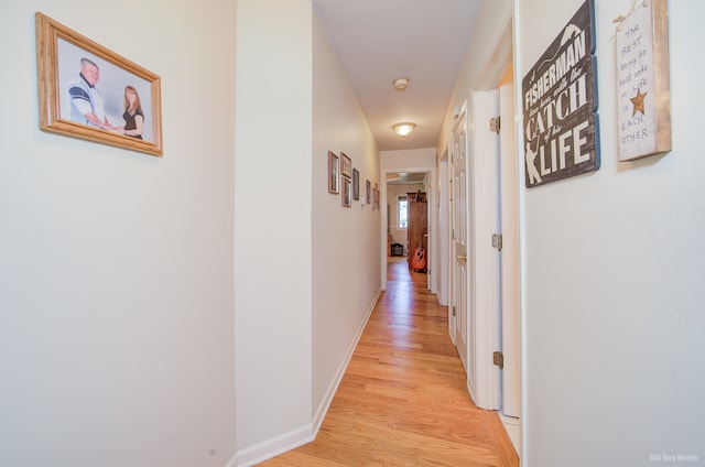 hallway with light hardwood / wood-style flooring