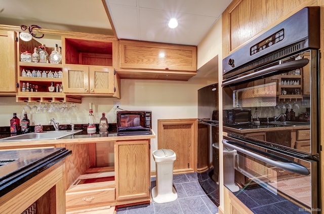 kitchen with decorative backsplash, black appliances, and sink