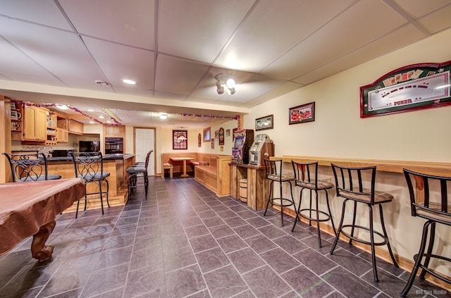 bar featuring oven, a drop ceiling, and billiards